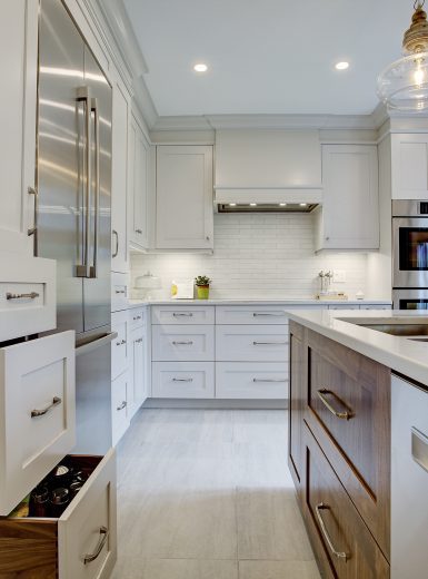classic kitchen, white cabinets, walnut cabinets, glass pendants, caesarstone counters, island (1)